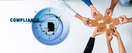 A group of diverse hands works together to assemble puzzle pieces, symbolizing compliance and...