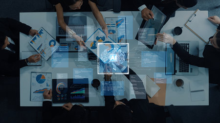 A diverse team collaborates in a modern office, utilizing data visualization and artificial intelligence to enhance strategic planning and decision-making processes.の写真素材