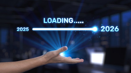 This image showcases a hand presenting a glowing loading bar between the years 2025 and 2026, symbolizing future progress and technological advancement in a modern office setting.の写真素材