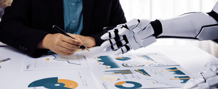 A business person and a robot collaborate on data analysis, examining graphs and charts in a modern...