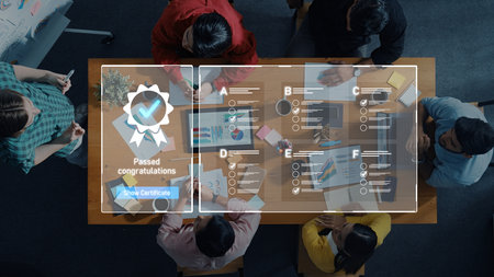 Diverse group of individuals gathered around a table celebrating a significant achievement, showcasing their teamwork and successful completion of tasks with a digital certificate. Tropeの写真素材
