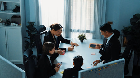 Top view of smart diverse marketing team prepare for business meeting. Professional businesspeople placed laptop and tablet with financial statistic at table. Creative business concept. Directorate.の写真素材
