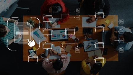 Overhead view of a diverse group collaborating in a modern workspace, engaging in discussions and sharing visual ideas using digital tools and documents. Rasterの写真素材