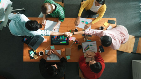 Top view of business team clapping hand and shaking hands together for celebrate successful...