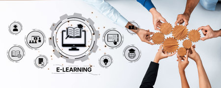 Engaging teamwork in e-learning demonstrates modern educational methods. Hands working together around a computer symbolize collaboration and innovation in digital learning.の写真素材