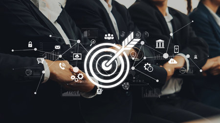 A professional business meeting showcases teamwork and ambition, featuring a digital interface that highlights goals and innovation for modern success. Rasterの写真素材