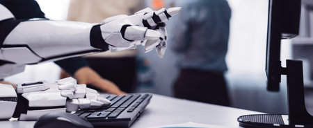 A close-up shot of a robotic arm interacting with a computer keyboard, showcasing modern technology...