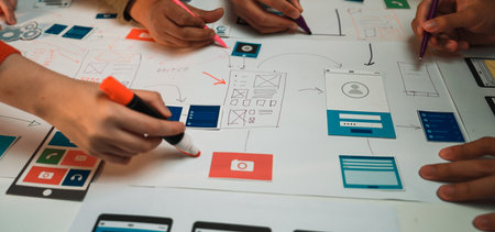 A group of creative individuals engaged in a productive design session for user interface layouts,...
