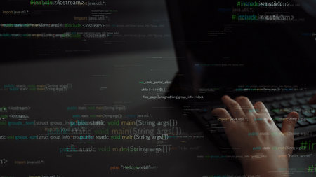 A close-up view of a person hand typing on a laptop, with translucent lines of code floating around, representing the dynamic world of programming and technology.の写真素材