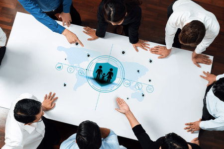 A diverse business team engages in strategic discussion while utilizing digital infographics. Their collaborative effort showcases innovation and growth potential in the modern office.の写真素材