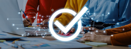 Members of a business team collaborate in a bright workspace. A digital check mark signifies success and approval in their project efforts, showcasing modern teamwork.の写真素材