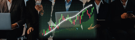 Business team engages with financial data using laptops and mobile devices, showcasing a growing...