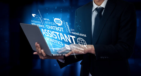 A professional wearing a suit holds a laptop displaying virtual concepts related to automation, chatbots, and knowledge systems, symbolizing technology in business.の写真素材