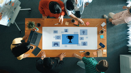 A dynamic team collaborates in a modern workspace, emphasizing teamwork and creativity, illustrated by a trophy icon that represents achievement and motivation.の写真素材