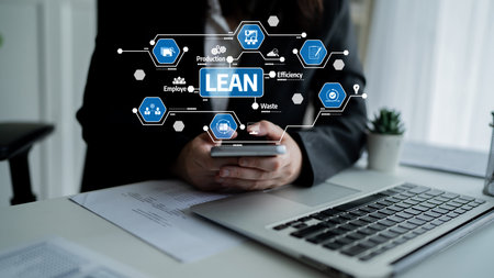 A business professional engages with a smartphone while surrounded by lean management graphics, symbolizing efficiency and modern workplace strategies.の写真素材