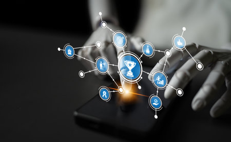 This image presents a modern smartphone surrounded by icons representing achievement and success, emphasizing motivation and digital connectivity in a professional context. Tesselの写真素材