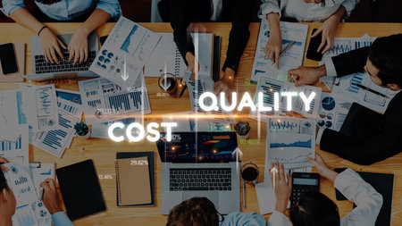 A collaborative office scene showcasing professionals engaged in strategic discussion around various graphs and charts focused on cost and quality management. Rasterの写真素材