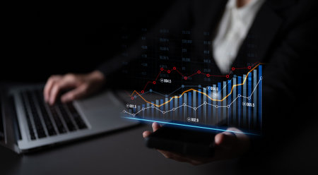 A professional focusing on business growth through data visualization, utilizing a laptop and...