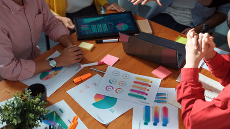Top down view of multicultural business group putting hand together to celebrate increasing sales or successful project. Close up of marketing team making stack of hand and clapping hand. Convocation.の写真素材