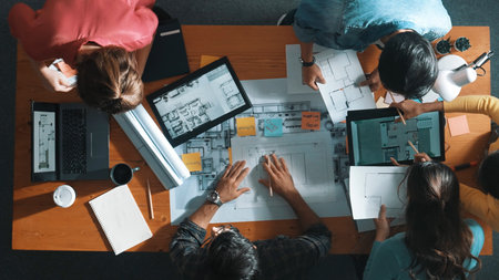 Top down view of manager writing project plan and sitting at meeting. Aerial view of business people...