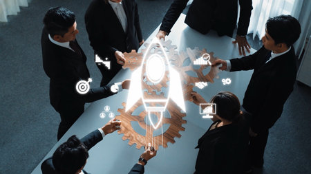 A diverse team of professionals collaborates on innovative business strategies, using gears and a rocket symbol to symbolize growth and success in a modern office setting. Rasterの写真素材