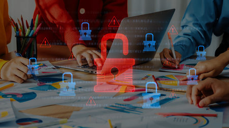 A dynamic teamwork scene showing hands engaged in project planning with a laptop and colorful...