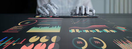 A professional uses hands to interact with a touchscreen displaying colorful graphs and charts. This image represents data analysis, business insights, and technology. Imputeの写真素材