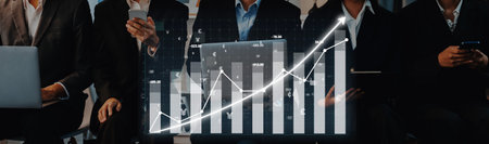 Group of business professionals uses digital devices to analyze financial data and discuss trends in...