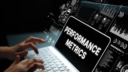 Hands Typing on Laptop with Digital Performance Metrics Dashboard Displayed on Screen in Dark...