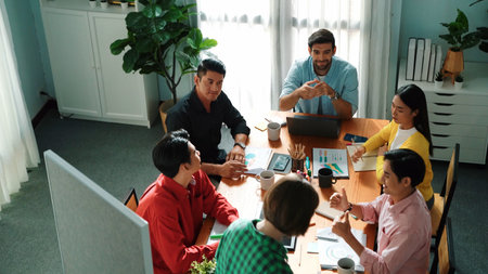 Top view of manager standing and present idea at whiteboard. Group of people listen presentation while clapping hand to encourage female leader. Team looking at leader talking about plan. Convocation.の写真素材