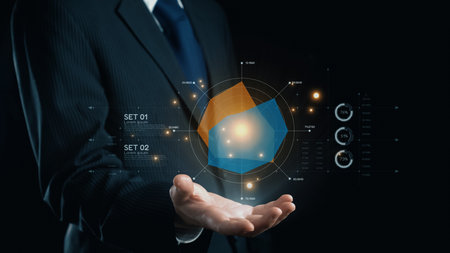 A businessman in a suit presents a futuristic data visualization with graphs and charts, symbolizing innovation and technology in corporate environments.の写真素材