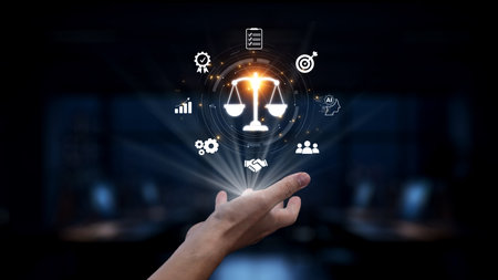 A conceptual image illustrating a hand holding legal scales surrounded by symbols of justice and technology, representing modern legal and ethical challenges in business. Synapseの写真素材