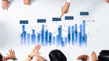 A group of professionals engaged in a business meeting, analyzing data trends displayed on a table,...
