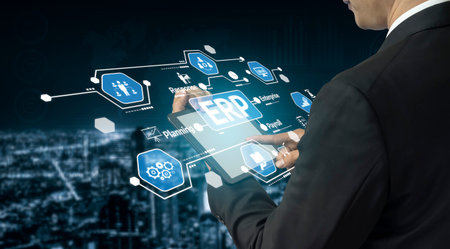 A businessman interacts with a tablet displaying digital icons related to enterprise resource...