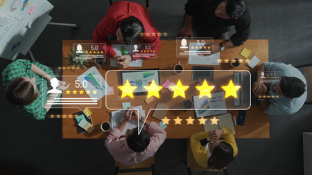 This image captures a team engaged in a strategic meeting, discussing positive customer feedback and high ratings to enhance business solutions and innovative strategies. Rasterの写真素材