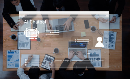 A group of business professionals engaged in a collaborative meeting utilizing an AI chatbot interface to enhance communication and strategy development.の写真素材