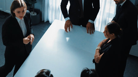 Top view of project manager looking at meeting table surrounded by diverse business people brainstorm and planning strategy. Group of smart people discussing and solve business problems. Directorate.の写真素材
