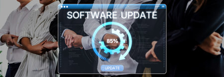 A diverse team of professionals collaborates on a software update process, with digital progress indication in a modern workspace, showcasing teamwork and innovation.の写真素材