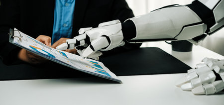 A unique scene depicting the interaction between a human and a robot in an office setting, highlighting the future of automation and teamwork in a professional environment.の写真素材