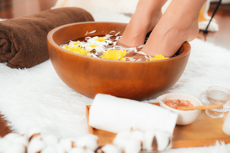 Woman indulges in blissful foot massage at luxurious spa salon while masseur give reflexology therapy in gentle day light ambiance resort or hotel foot spa. Quiescentの写真素材