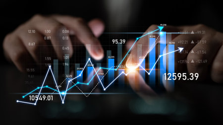A professional setup featuring hands interacting with a digital tablet displaying rising financial...
