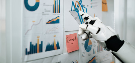 A robotic arm points to various graphs and charts displayed on a wall, showcasing data analysis and visualization in a modern workspace.の写真素材