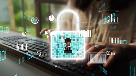 Close-up of a person typing on a keyboard with digital representations of a padlock and data,...