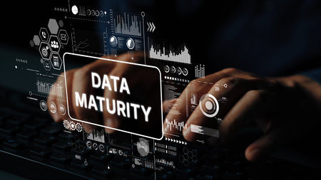 Hands Typing on Keyboard with Data Maturity Concept and Digital Analytics Graphics in Background. Asymptotic smart data analytic.の写真素材