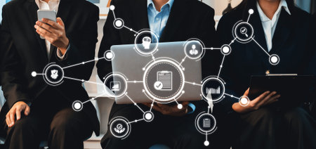 A group of business professionals engaged in digital communication, showcasing modern technology and collaboration. Ideal for concepts of networking and teamwork.の写真素材