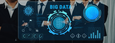 A group of business professionals stand confidently as they analyze big data trends displayed on a...
