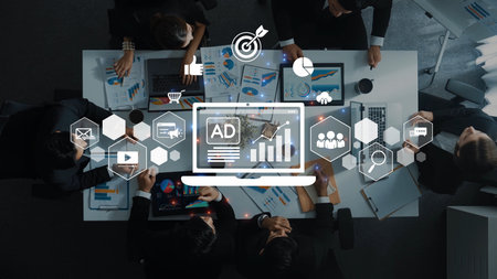 A captivating overhead view of a business meeting featuring professionals analyzing data, with digital marketing graphics highlighting crucial insights and strategies. Rasterの写真素材