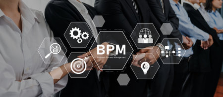 Professionals in business attire collaborate on innovative strategies for effective business process management, focusing on performance and organizational efficiency.の写真素材
