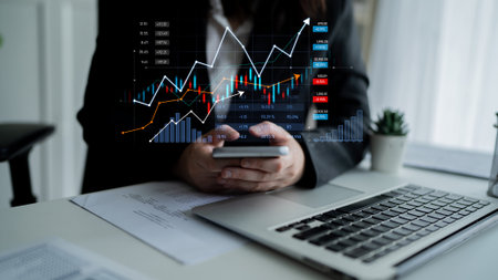 A business professional engages with financial data on a smartphone, displaying various growth...
