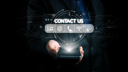 A hand holds a smartphone, featuring glowing digital icons like contact us, email, and phone, showcasing the essence of modern connectivity and technology in communication.の写真素材